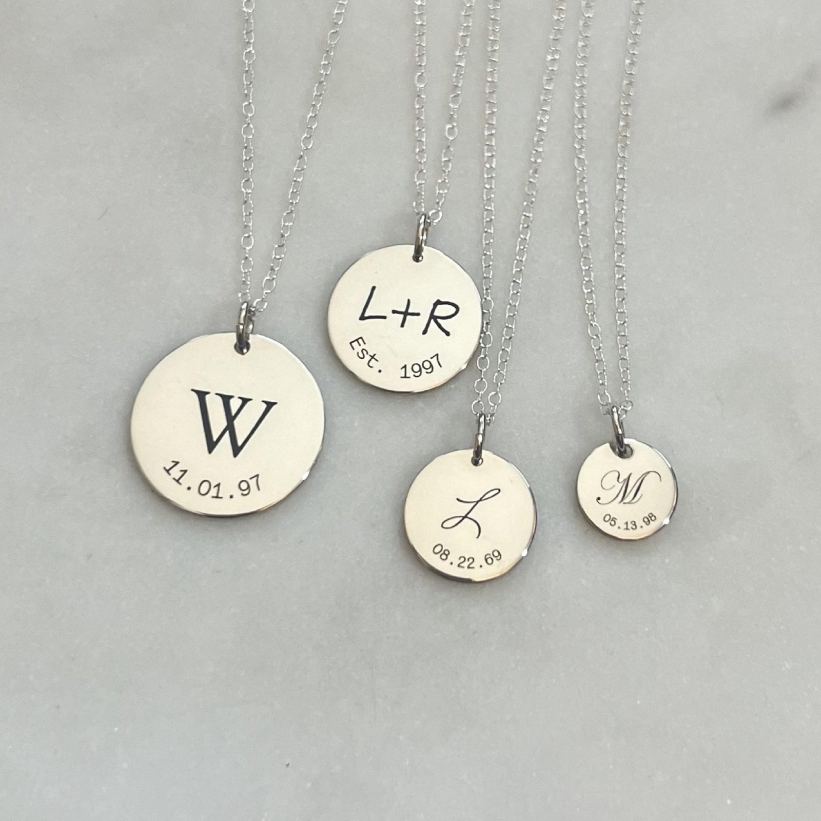 4 sterling silver disc pendants with intials and curved dates from laurane elisabeth