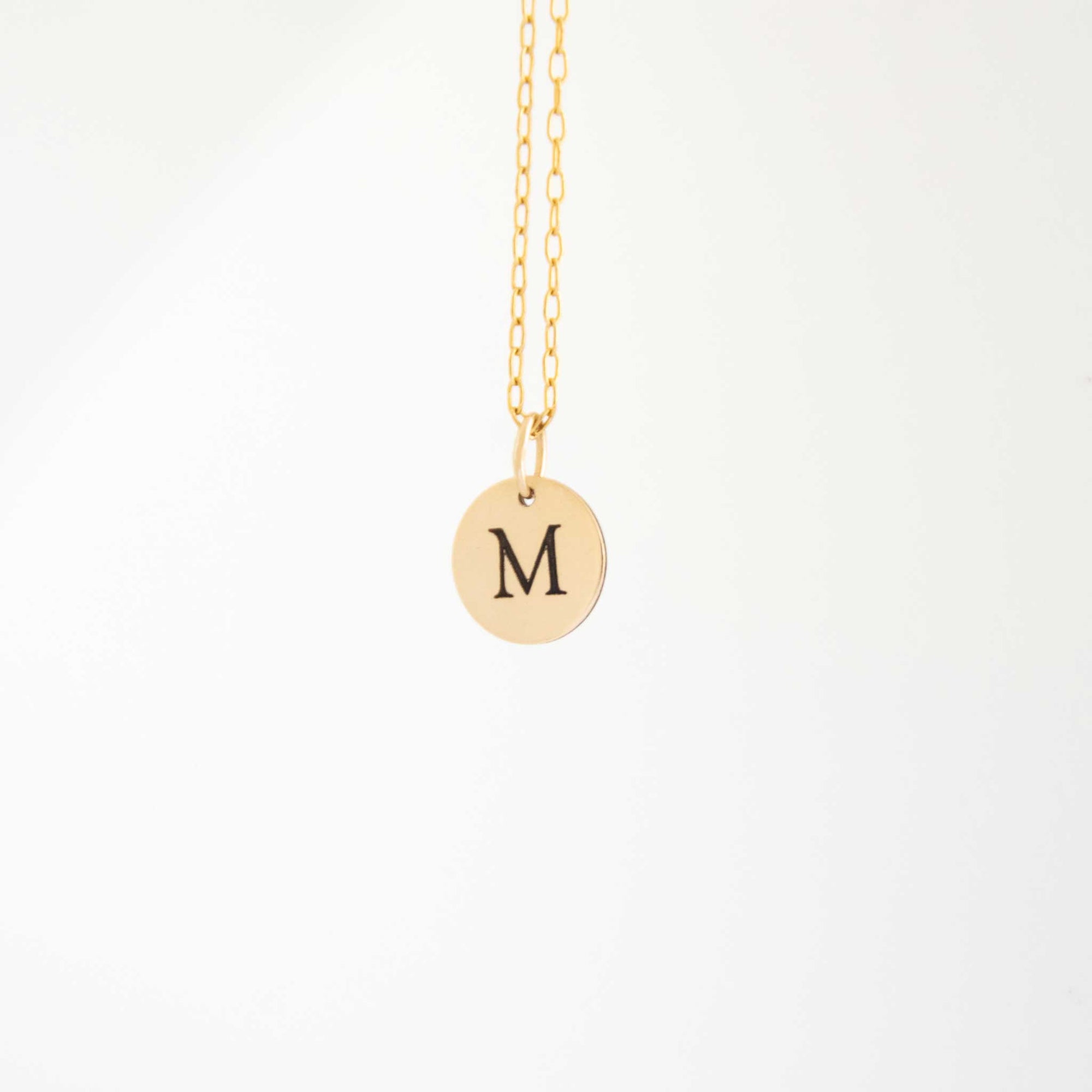 The 10mm circle necklace hanging with a solid white background behind.