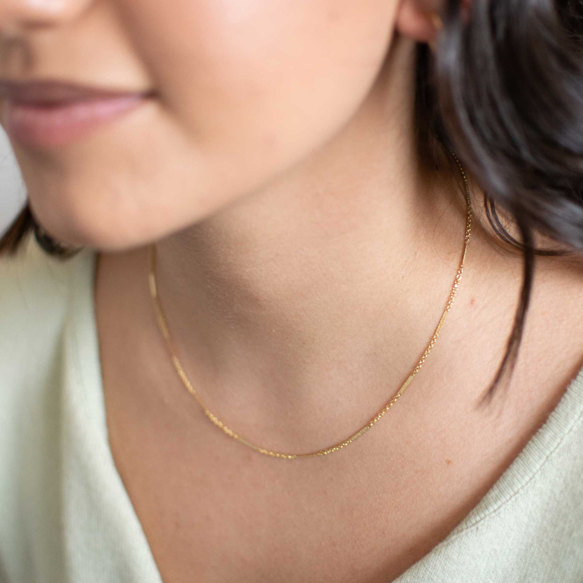 Gold Bar Necklace worn by a woman. 