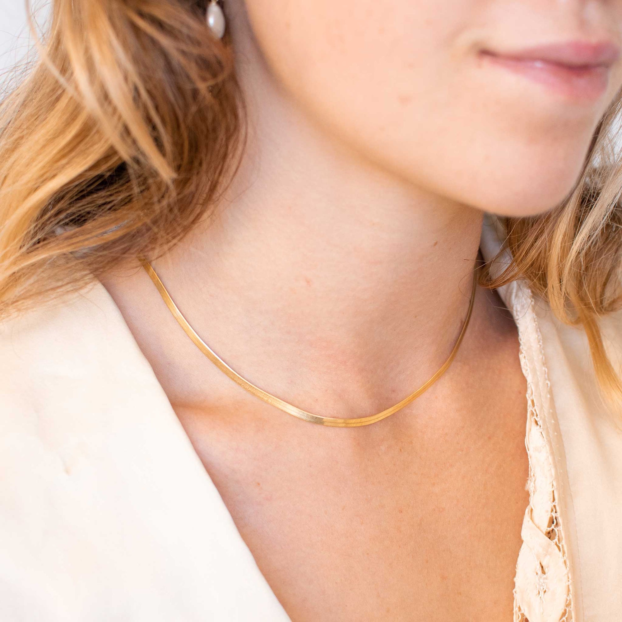  A close up of a woman wearing the gold vermeil chain necklace. 