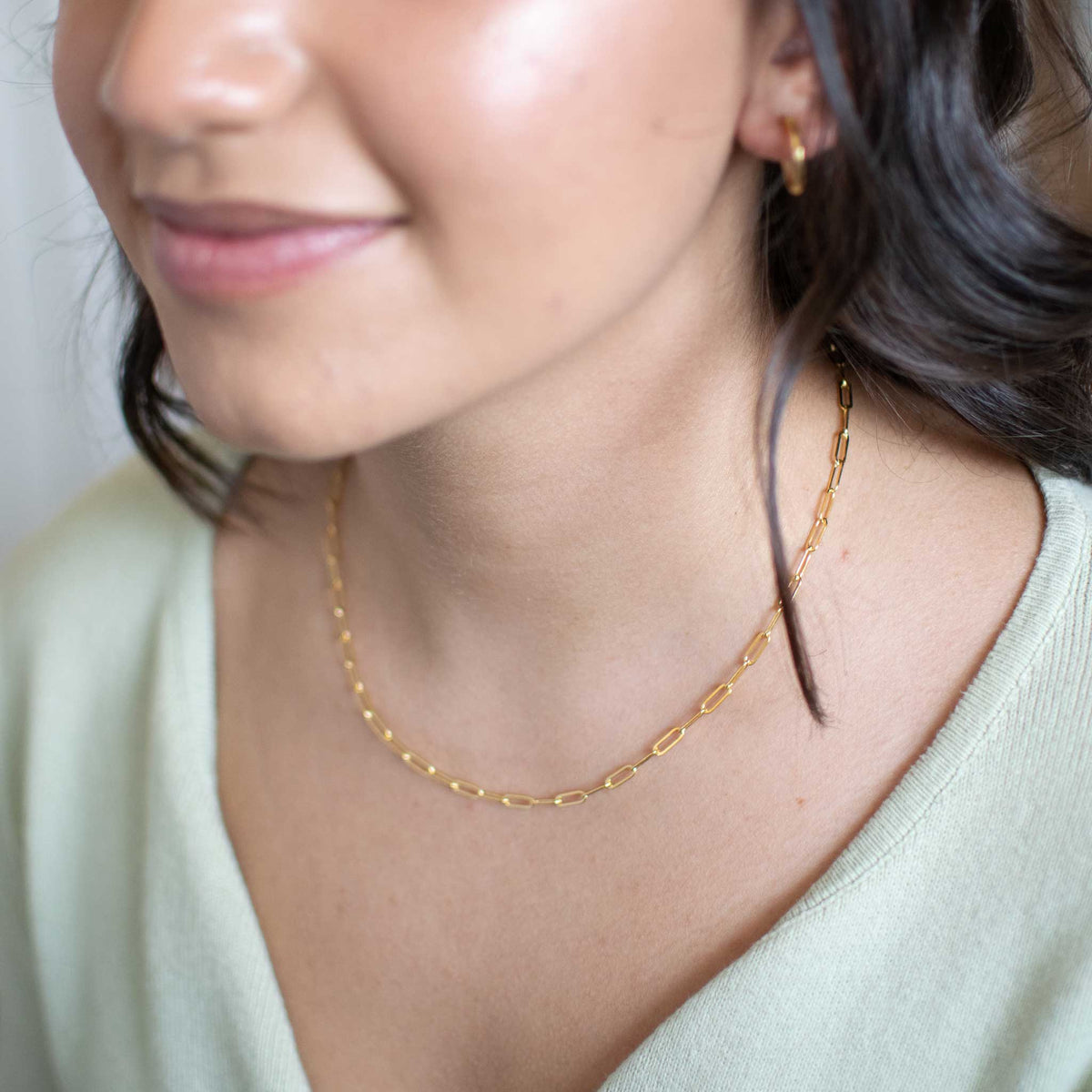 The bold link necklace worn by a woman.