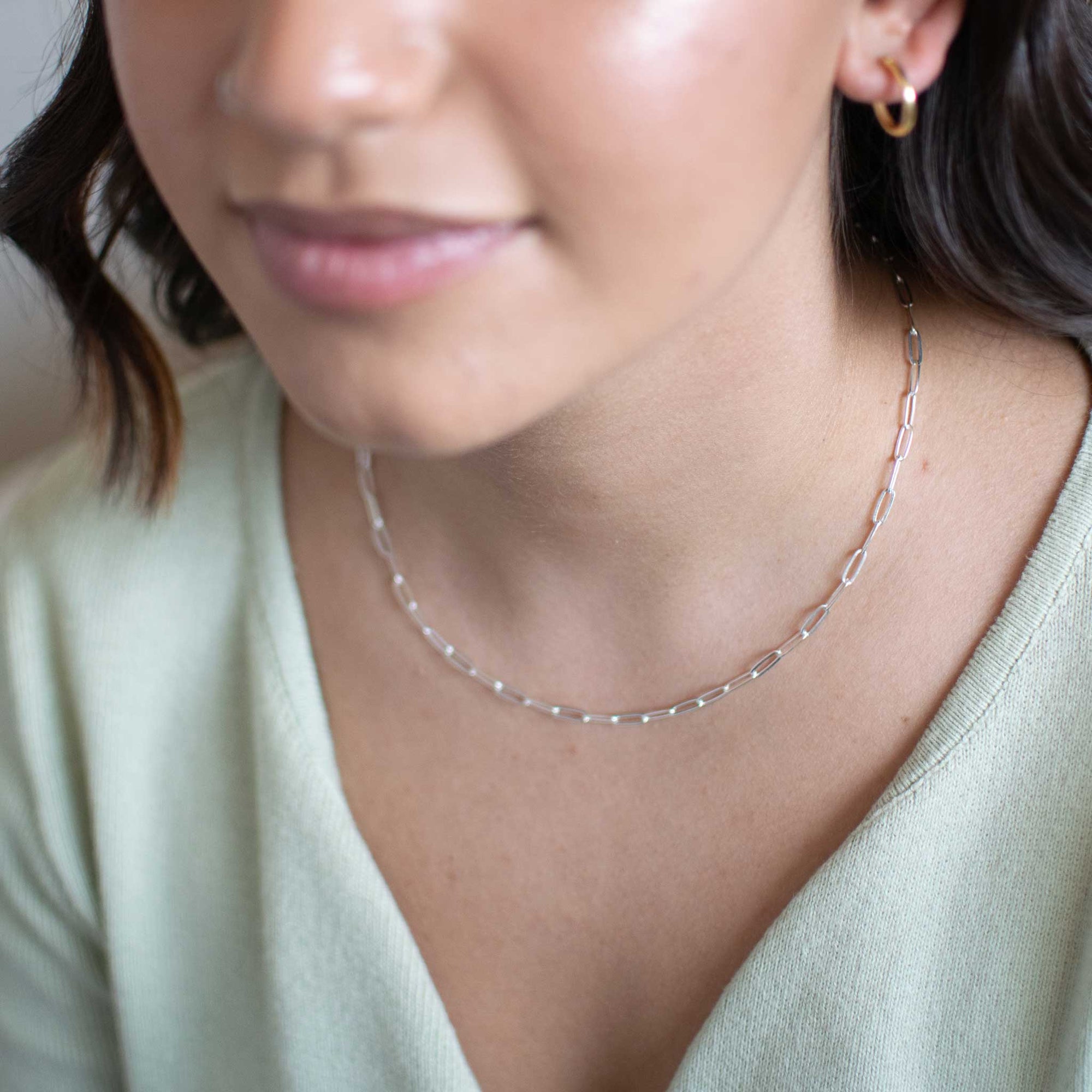 up close shot of the model wearing the bold link sterling silver chain. 