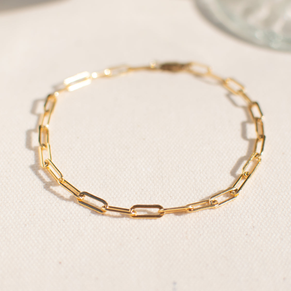 Close up of the bold link bracelet only partially focused in the front on a white background.