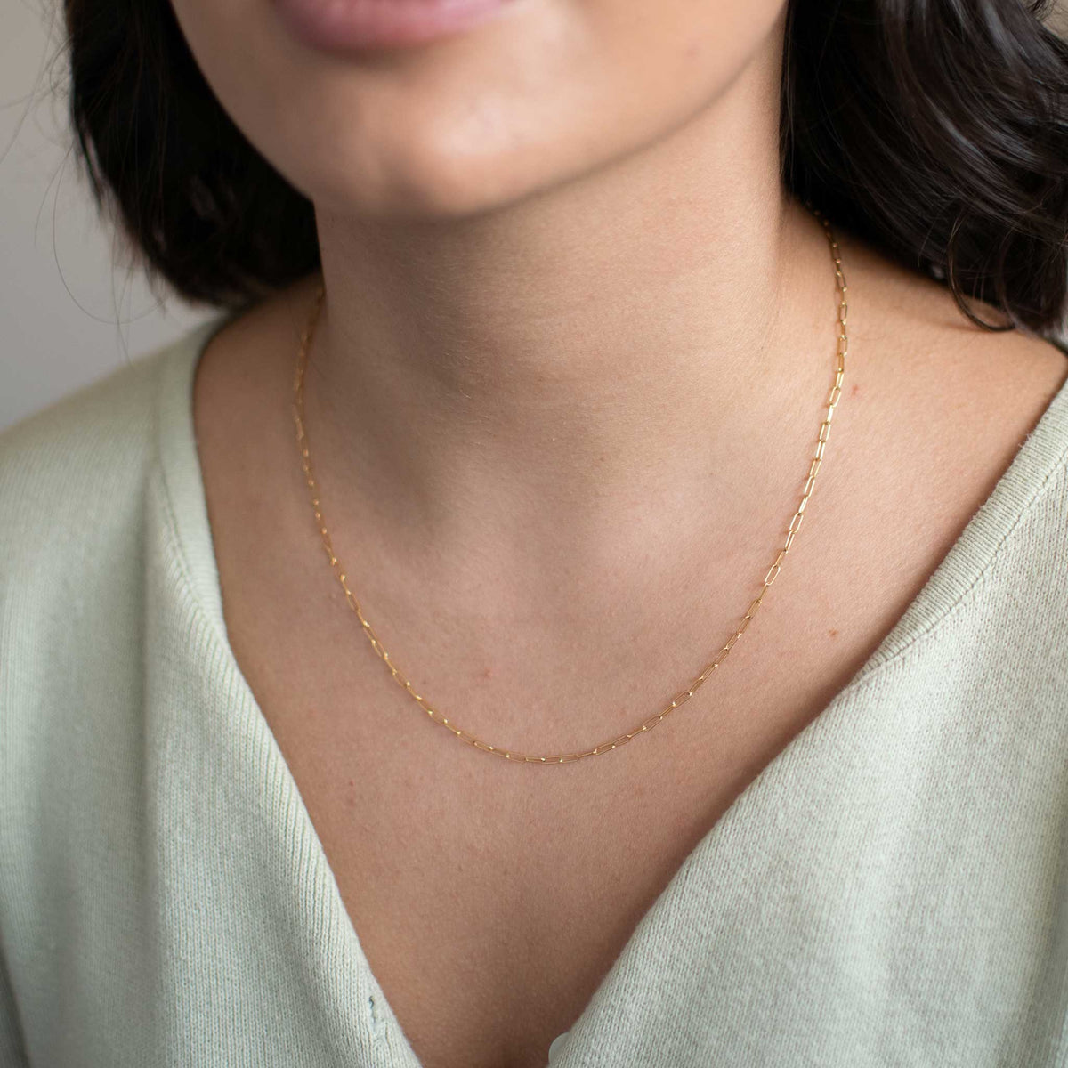 Front view of the small link chain worn by a woman. 